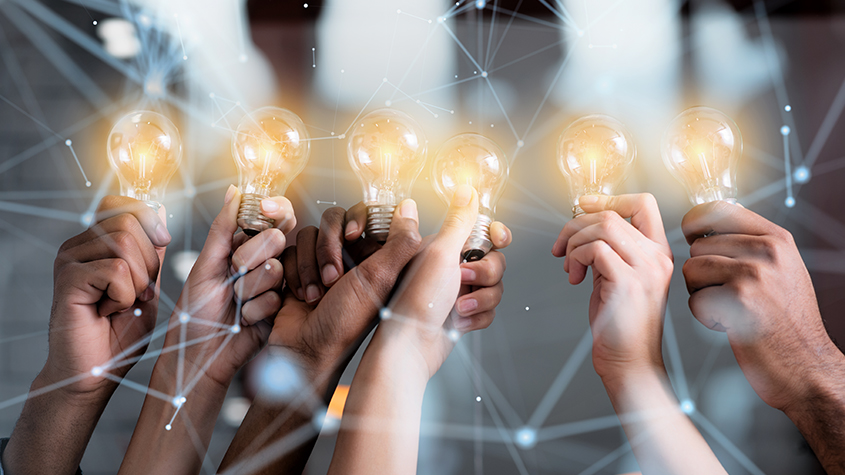 people holding light bulbs as a representation of brainstorming session with teammates conducive of knowledge sharing